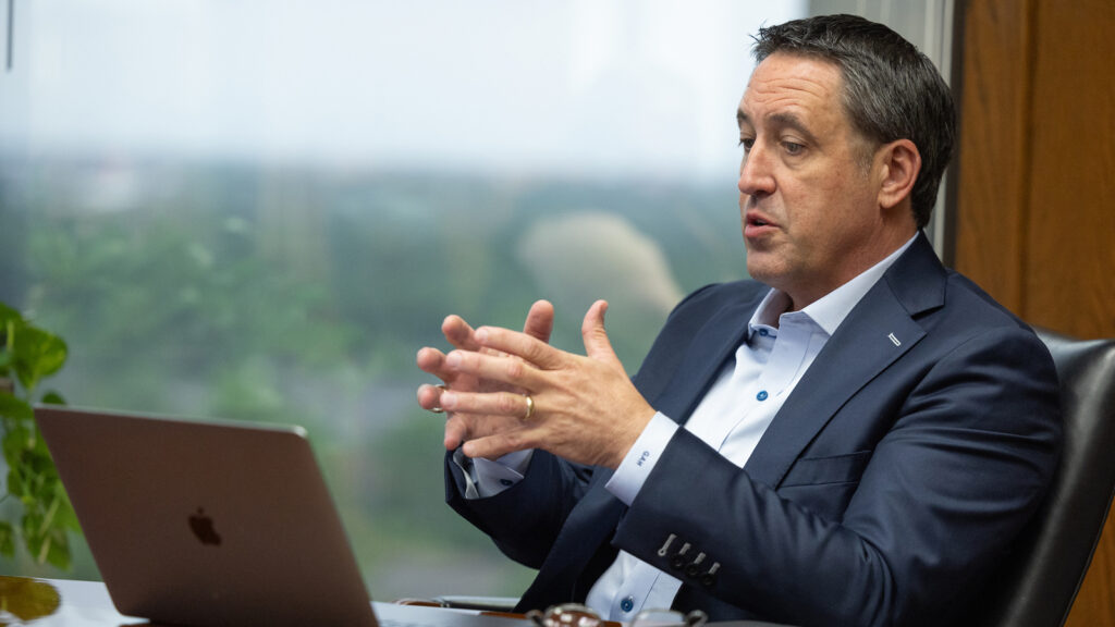 Glenn Hegar sitting at a desk while talking