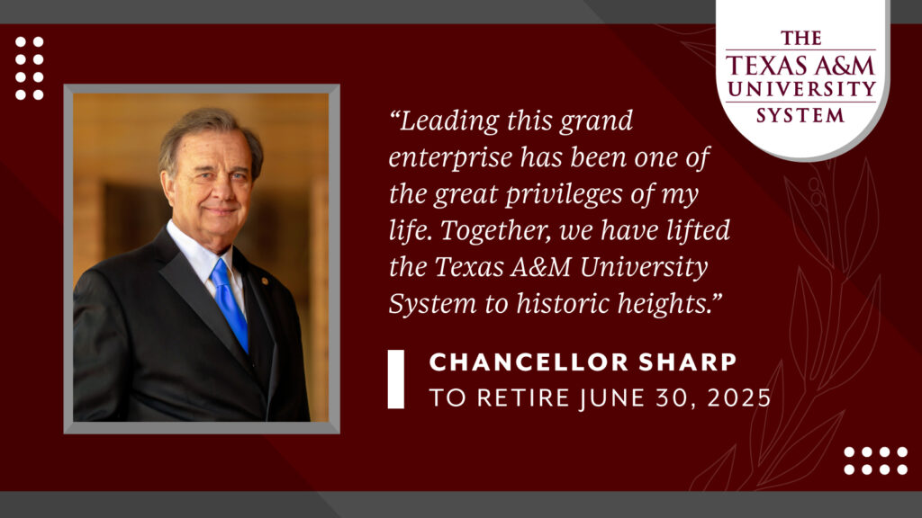 John Sharp smiles wearing a suite and looking at the camera.