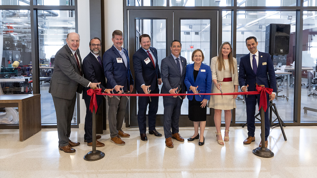 A group of people take part in the ribbon cutting at the STEM Education and Research Center at RELLIS