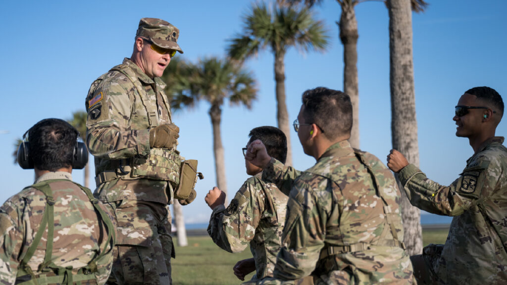ROTC members are seen in an outdoor setting.