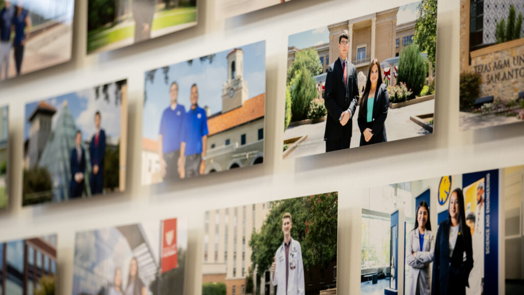 Student portraits displayed on a wall.